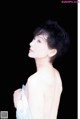 A woman in a white dress is posing for a picture.