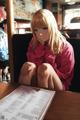 A woman sitting at a table in a restaurant.