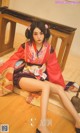 A woman in a kimono sitting on the floor.