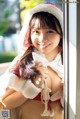 A woman in a red and white outfit is posing for a picture.