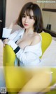 a woman sitting on top of a yellow chair